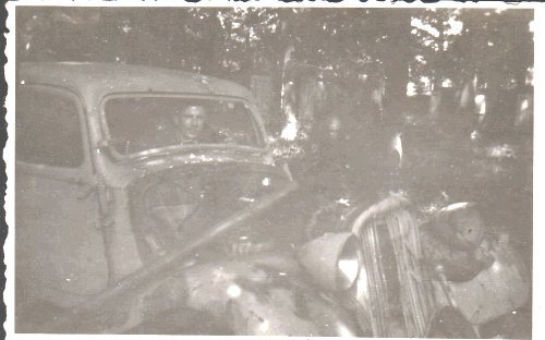 John Edward Olsen in a broken German car