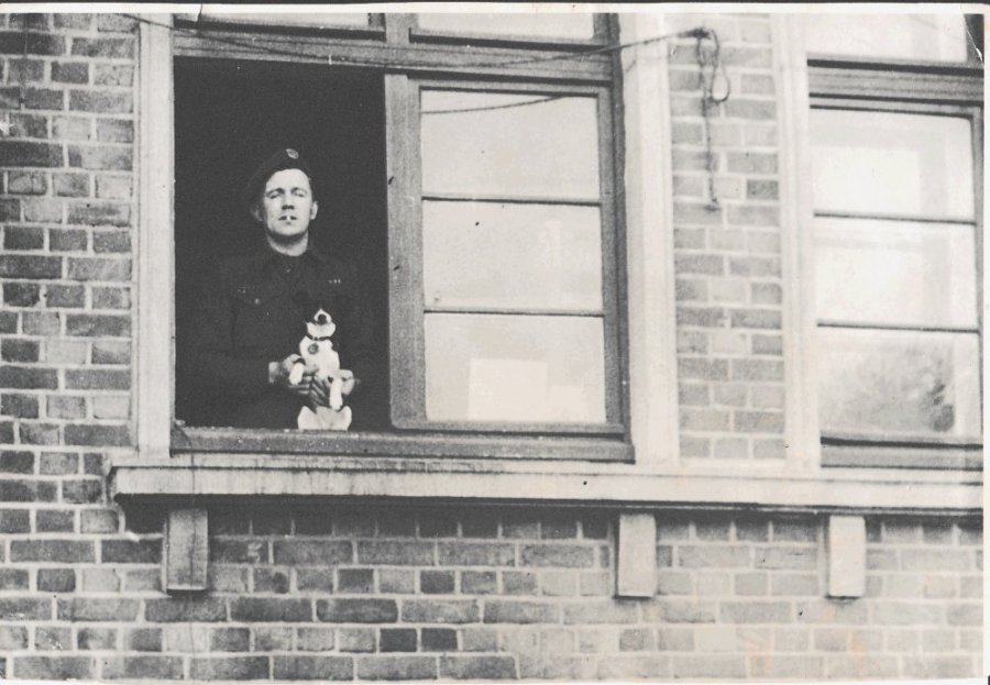 John Edward Olsen in his barracks with his dog in Germany